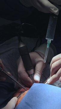 Close-up of surgical hands performing an underground medical operation