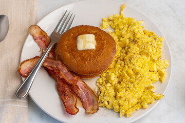 scramble eggs  with pancakes with bacon
