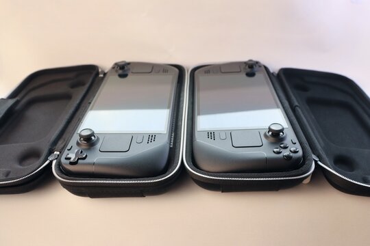 Portable game consoles in protective cases &mdash; the concept of mobile gaming, travel, and a tech-savvy lifestyle