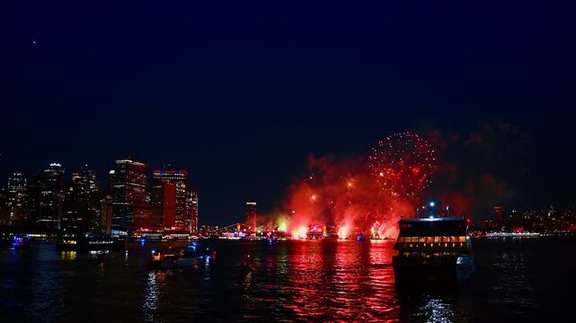 Firework show over the riverscape at night. Beautiful celebration of the 4th July in New York, USA.