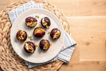 A plate of fruit with nuts and herbs on top