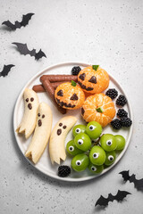 A plate of Halloween themed fruit and vegetables