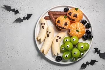 A plate of Halloween themed fruit and vegetables
