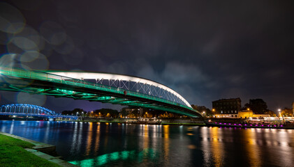 Illuminated pedestrian bridge and steel road bridge at night in Krakow
Stunning nighttime scene...