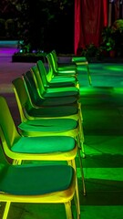 Obraz premium Green chairs in a row lit by lights