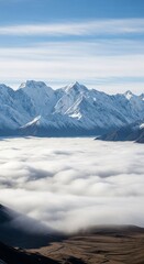 Snowy mountain peaks rising above a dense cloud inversion, creating a stunning winter landscape view for nature and travel