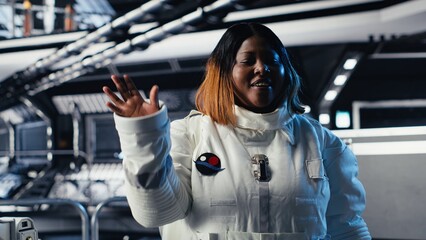 Joyous astronaut greeting command center researchers during videocall, presenting analysis findings. Smiling orbit station crew member provides scientific findings to Earth team