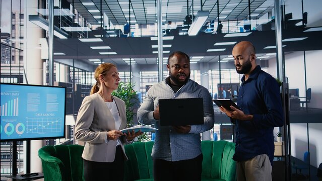 Multiethnic group of business partners discussing about a new growth strategy, goal oriented specialists ensuring global development and a success story. Networking. Camera A.