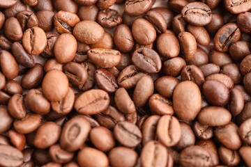 Coffee texture roasted beans from above soft light close up