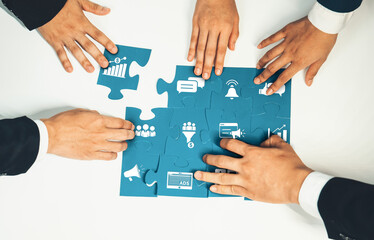 A captivating scene showcasing hands working together to assemble puzzle pieces with various icons, symbolizing teamwork and strategic planning in marketing and business environments. Amity