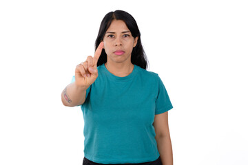 woman wearing a green shirt on a white background making a no sign, negation