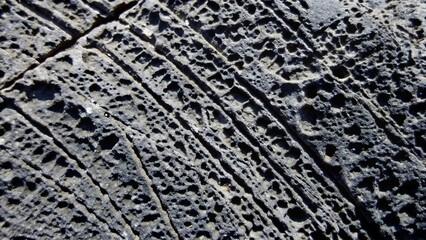 Weathered dark basalt rock erosion texture surface