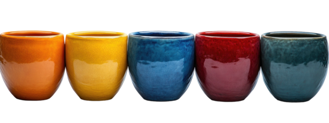 Five colorful ceramic cups stand in a line against a black background