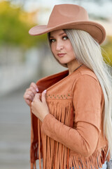 Young woman in western fashion at golden hour outdoors