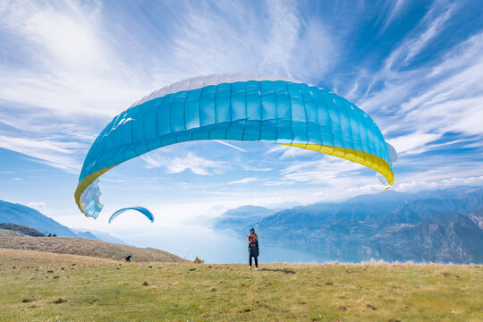 A paraglider preparing for the flight on the Monte Baldo mountain, on the Garda lake, Italy