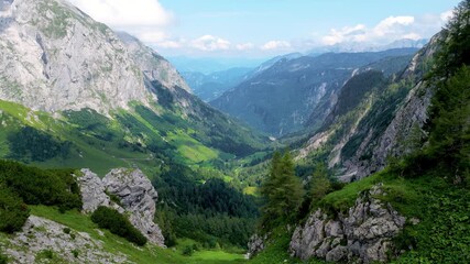 Scenic 4K aerial view of the Berchtesgaden Alps near the Austrian border, Oberloiben area. Majestic mountain peaks, green valleys, and summer clouds in Bavaria, Germany. - Powered by Adobe