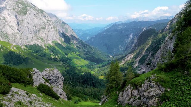Scenic 4K aerial view of the Berchtesgaden Alps near the Austrian border, Oberloiben area. Majestic mountain peaks, green valleys, and summer clouds in Bavaria, Germany.