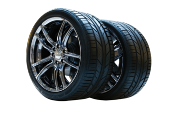 Two car tires with shiny rims isolated against a black background