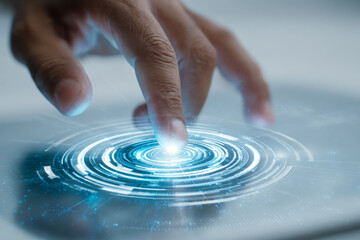 Person interacting with futuristic digital interface featuring glowing circular holograms and technology elements on a transparent touch screen panel