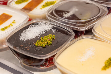 Close-Up of Traditional Turkish Rice Puddings with Spangles and Nuts
