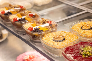 Close-Up of Traditional Turkish Rice Puddings with Spangles and Nuts
