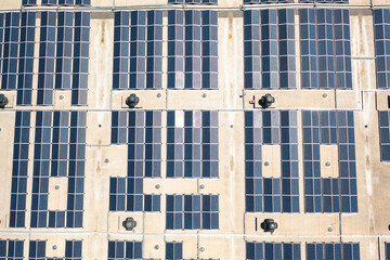Solar panels installed on rooftop, harnessing renewable energy to power buildings with sustainable technology and contributing to environmental conservation. Aerial drone shot