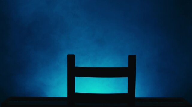 Empty chair and piano in dramatic lighting