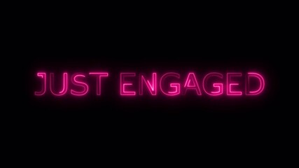 Just engaged text in vibrant pink neon against a dark background perfect for engagement announcements.