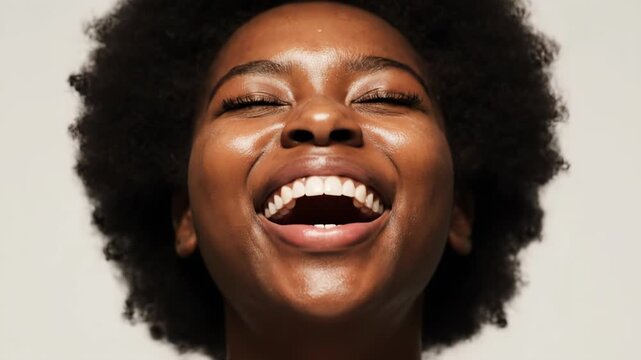 A beautiful black woman with natural afro hair laughing with her eyes closed and hands near her face, isolated on white background vector illustration