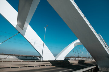 Zezelj Bridge in Novi Sad, Serbia, modern white arch bridge over the Danube River on a sunny day.