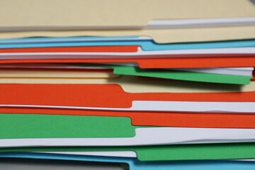 Many documents in folders on table, closeup
