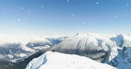 Fototapete Landschaft Image of Christmas winter scenery with countryside mountains blue sky and snowflakes falling  © vectorfusionart