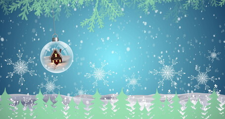 Image of snow falling over snow globe and fir tree decoration