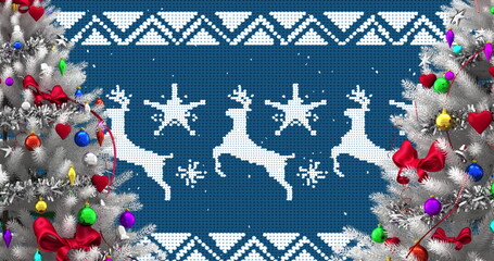 Image of snow falling over christmas baubles on trees decoration on blue background