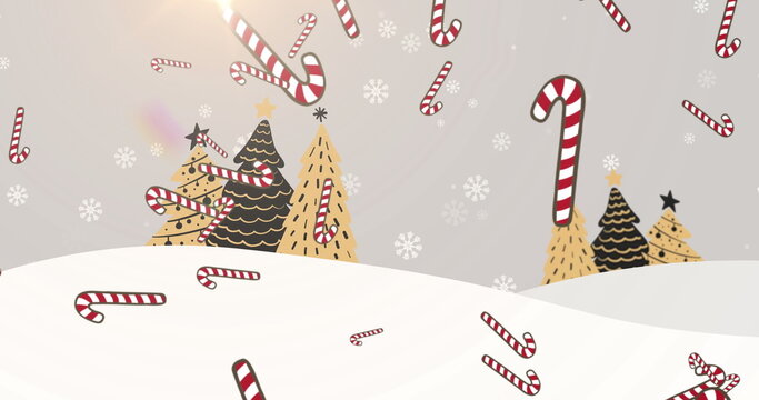 Naklejki Image of candy cane and snow falling over winter landscape