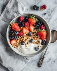 Granola bowl with berries and yogurt on marble surface, editorial breakfast composition highlighting health, nutrition, and the fresh simplicity of modern wellness lifestyle