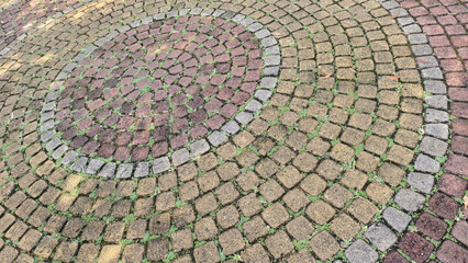 Fototapeta premium a cobblestone pavement with circular pattern. paving roads, pathways and driveways. horizontal view
