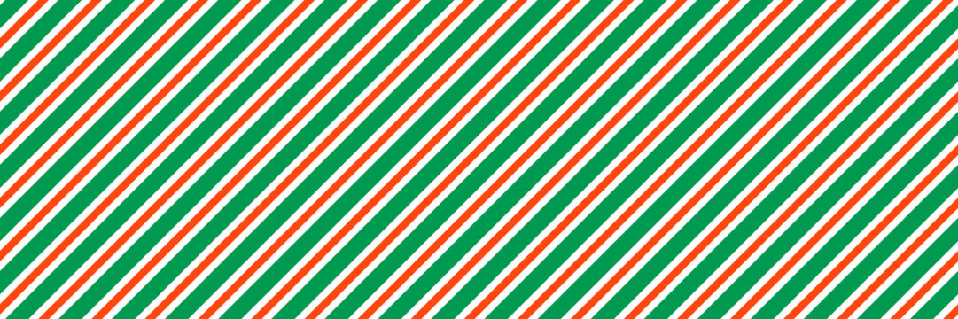Striped candy cane Christmas seamless pattern. Red and green diagonal lines wallpaper. Winter holiday present wrapping paper. Vector gift decor backdrop. Xmas peppermint repeating background