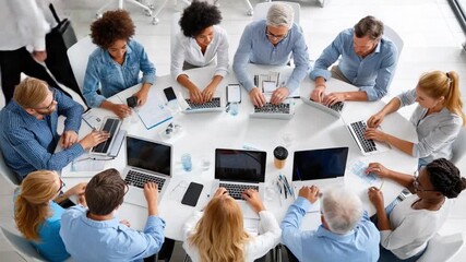 Business Discussion around Round Table: A collaborative business discussion unfolds around a large, round table, where colleagues engage in active brainstorming, utilizing technology. - Powered by Adobe