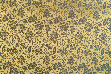 Beautiful texture of paper Wallpaper embossed in form of a classic floral ornament in golden tones.