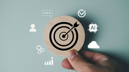 Business target concept with a hand holding wooden dartboard icon surrounded by AI, cloud, user, analytics, and communication symbols, representing digital marketing and goal setting strategy.