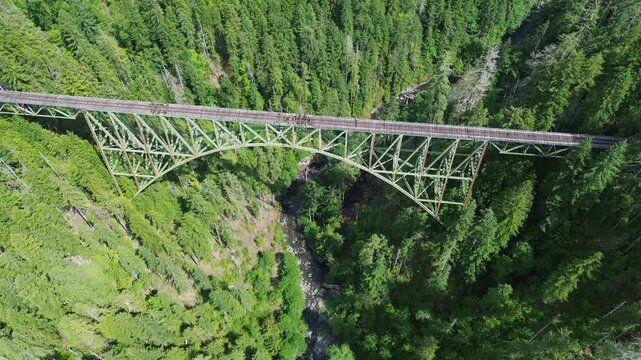 Abandoned Vance railroad bridge in western Washington. High angle flyover shot of the bridge shows the damaged tracks, with the canyon below.