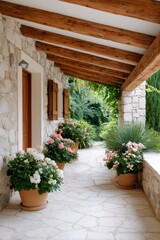 Fototapeta premium Mediterranean stone house patio with potted geraniums