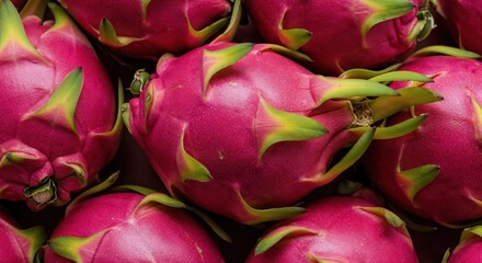 Vibrant Dragon Fruit Display: A close-up captures an array of dragon fruits, showcasing their exotic, vivid magenta hues and distinctive scales, promising a burst of tropical sweetness.