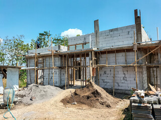 The view of the building of the resident's house in the middle of the rice field. Construction of building of concrete house.