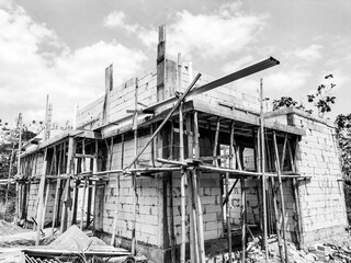 The view of the building of the resident's house in the middle of the rice field. Construction of building of concrete house.