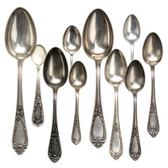 Assortment of ornate silver spoons displayed against a dark background.