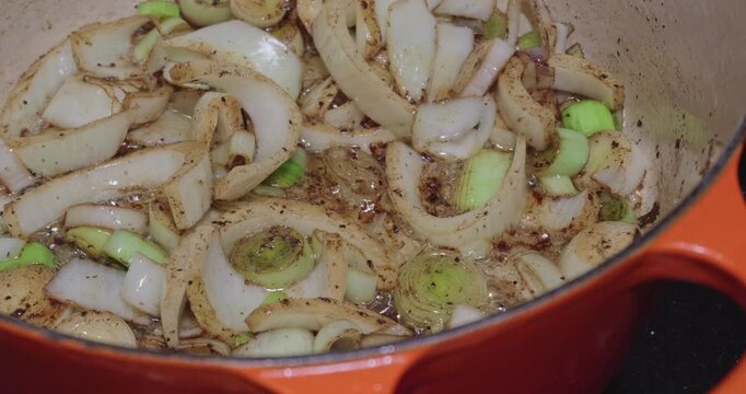 Leeks, Fennel, and Onions Sweating in Rendered Fat for a Flavor Base