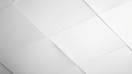 A clean white tiled ceiling arranged in a precise grid pattern with visible seams,