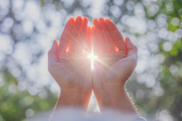 Human hands respect and pray to God on nature bokeh background